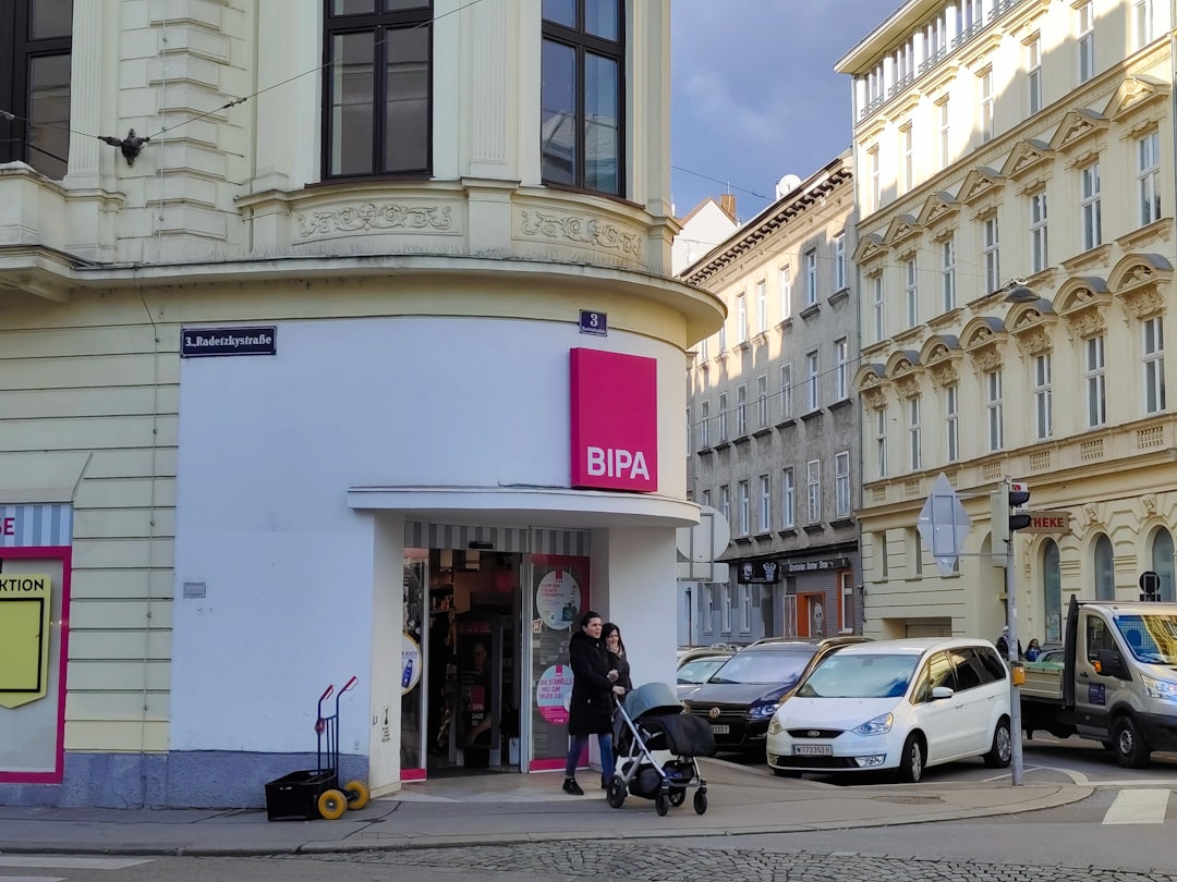 a woman pushing a stroller in front of a store