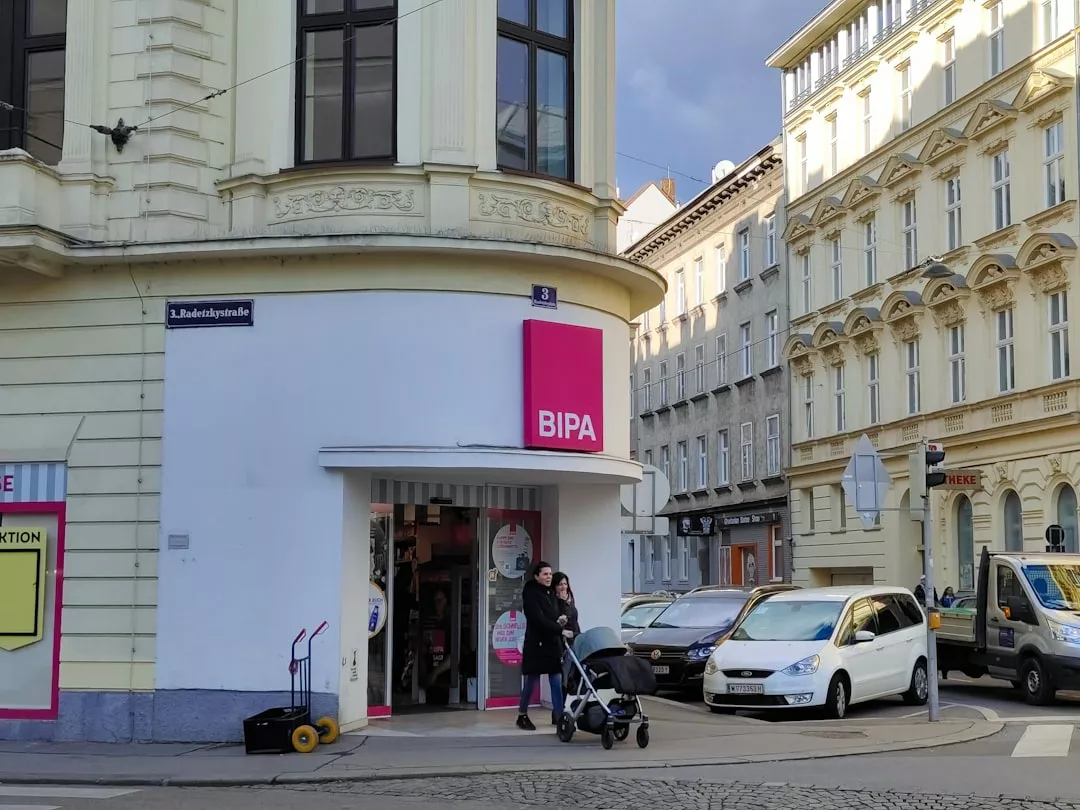 a woman pushing a stroller in front of a store